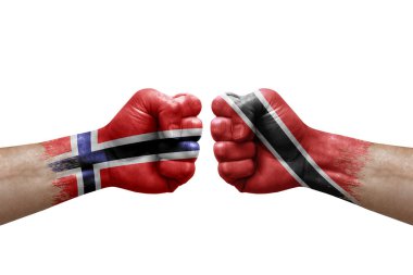 Two hands punch to each others on white background. Country flags painted fists, conflict crisis concept between norway and tobago