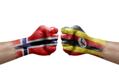 Two hands punch to each others on white background. Country flags painted fists, conflict crisis concept between norway and uganda