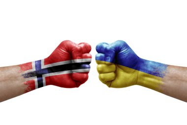 Two hands punch to each others on white background. Country flags painted fists, conflict crisis concept between norway and ukraine