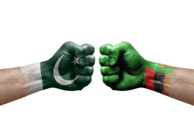 Two hands punch to each others on white background. Country flags painted fists, conflict crisis concept between pakistan and zambia