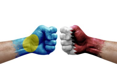 Two hands punch to each others on white background. Country flags painted fists, conflict crisis concept between palau and qatar