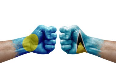 Two hands punch to each others on white background. Country flags painted fists, conflict crisis concept between palau and saint lucia