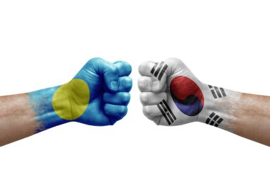 Two hands punch to each others on white background. Country flags painted fists, conflict crisis concept between palau and south korea