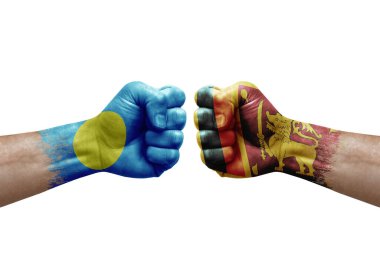 Two hands punch to each others on white background. Country flags painted fists, conflict crisis concept between palau and sri lanka