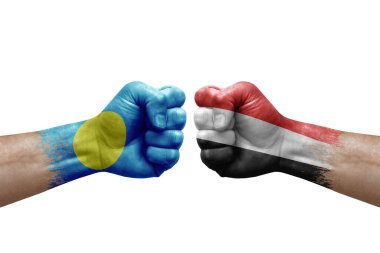 Two hands punch to each others on white background. Country flags painted fists, conflict crisis concept between palau and yemen
