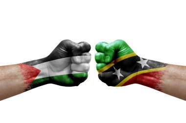 Two hands punch to each others on white background. Country flags painted fists, conflict crisis concept between palestine and saint kitts and nevis