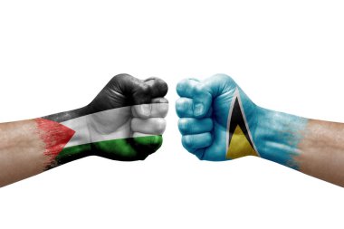 Two hands punch to each others on white background. Country flags painted fists, conflict crisis concept between palestine and saint lucia