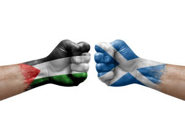 Two hands punch to each others on white background. Country flags painted fists, conflict crisis concept between palestine and scotland