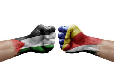 Two hands punch to each others on white background. Country flags painted fists, conflict crisis concept between palestine and seychelles