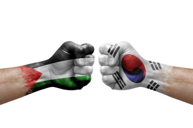 Two hands punch to each others on white background. Country flags painted fists, conflict crisis concept between palestine and south korea