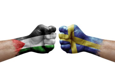 Two hands punch to each others on white background. Country flags painted fists, conflict crisis concept between palestine and sweden