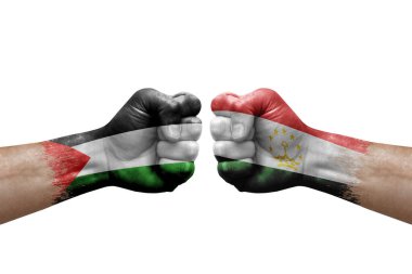 Two hands punch to each others on white background. Country flags painted fists, conflict crisis concept between palestine and tajikistan