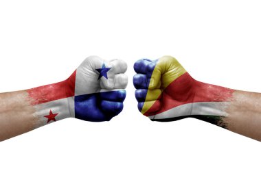 Two hands punch to each others on white background. Country flags painted fists, conflict crisis concept between panama and seychelles