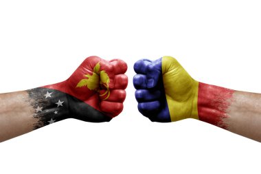 Two hands punch to each others on white background. Country flags painted fists, conflict crisis concept between papua new guinea and romania