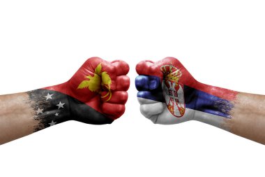 Two hands punch to each others on white background. Country flags painted fists, conflict crisis concept between papua new guinea and serbia