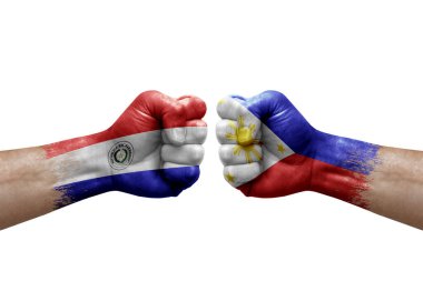 Two hands punch to each others on white background. Country flags painted fists, conflict crisis concept between paraguay and philippines