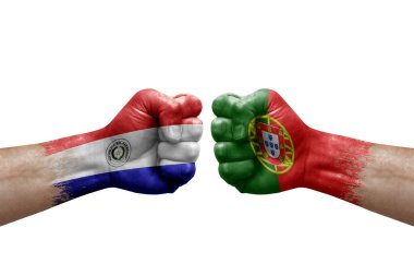 Two hands punch to each others on white background. Country flags painted fists, conflict crisis concept between paraguay and portugal