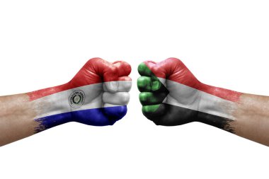Two hands punch to each others on white background. Country flags painted fists, conflict crisis concept between paraguay and sudan