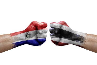 Two hands punch to each others on white background. Country flags painted fists, conflict crisis concept between paraguay and thailand
