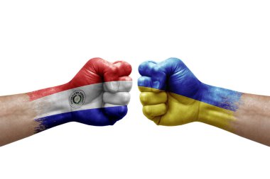 Two hands punch to each others on white background. Country flags painted fists, conflict crisis concept between paraguay and ukraine