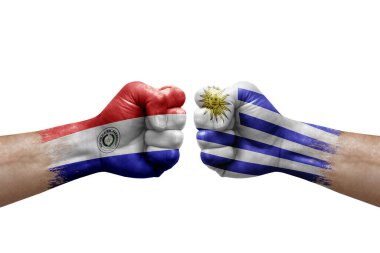 Two hands punch to each others on white background. Country flags painted fists, conflict crisis concept between paraguay and uruguay