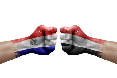 Two hands punch to each others on white background. Country flags painted fists, conflict crisis concept between paraguay and yemen