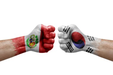 Two hands punch to each others on white background. Country flags painted fists, conflict crisis concept between peru and south korea