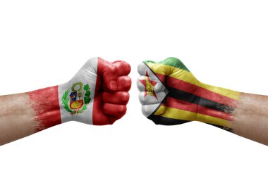 Two hands punch to each others on white background. Country flags painted fists, conflict crisis concept between peru and zimbabwe