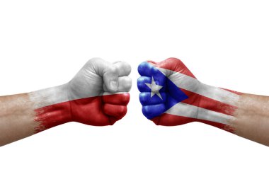 Two hands punch to each others on white background. Country flags painted fists, conflict crisis concept between poland and puerto rico