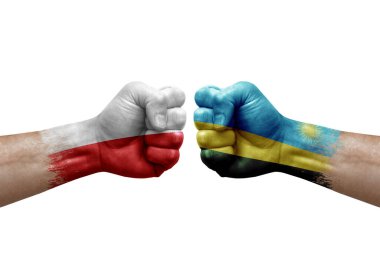 Two hands punch to each others on white background. Country flags painted fists, conflict crisis concept between poland and rwanda