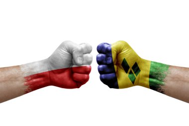 Two hands punch to each others on white background. Country flags painted fists, conflict crisis concept between poland and saint vincent and the grenadines