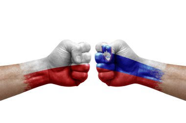 Two hands punch to each others on white background. Country flags painted fists, conflict crisis concept between poland and slovenia