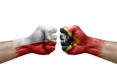 Two hands punch to each others on white background. Country flags painted fists, conflict crisis concept between poland and timor leste