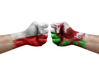 Two hands punch to each others on white background. Country flags painted fists, conflict crisis concept between poland and wales