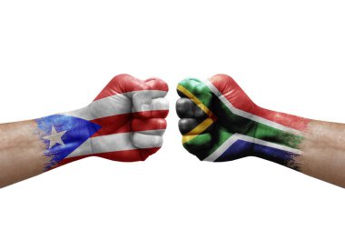 Two hands punch to each others on white background. Country flags painted fists, conflict crisis concept between puerto rico and south africa
