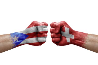 Two hands punch to each others on white background. Country flags painted fists, conflict crisis concept between puerto rico and switzerland