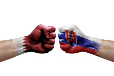 Two hands punch to each others on white background. Country flags painted fists, conflict crisis concept between qatar and slovakia