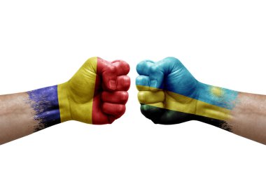 Two hands punch to each others on white background. Country flags painted fists, conflict crisis concept between romania and rwanda
