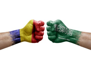 Two hands punch to each others on white background. Country flags painted fists, conflict crisis concept between romania and saudi arabia