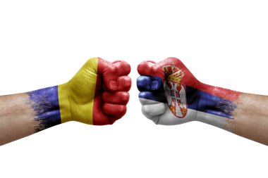 Two hands punch to each others on white background. Country flags painted fists, conflict crisis concept between romania and serbia