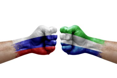 Two hands punch to each others on white background. Country flags painted fists, conflict crisis concept between russia and sierra leone