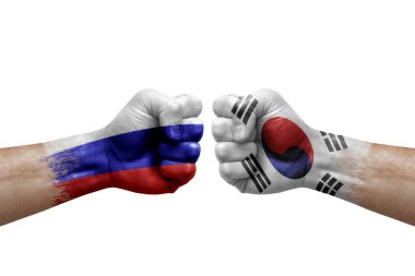Two hands punch to each others on white background. Country flags painted fists, conflict crisis concept between russia and south korea