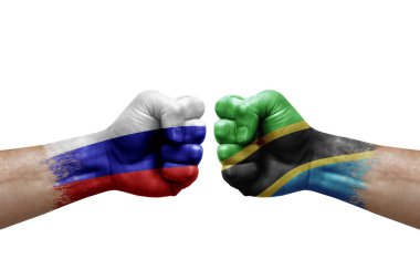 Two hands punch to each others on white background. Country flags painted fists, conflict crisis concept between russia and tanzania