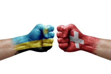 Two hands punch to each others on white background. Country flags painted fists, conflict crisis concept between rwanda and switzerland