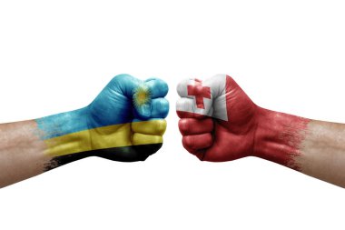 Two hands punch to each others on white background. Country flags painted fists, conflict crisis concept between rwanda and tonga