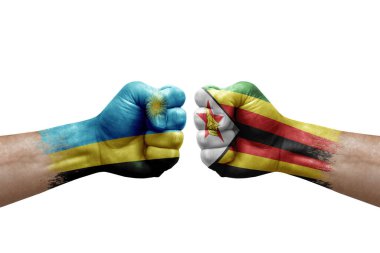 Two hands punch to each others on white background. Country flags painted fists, conflict crisis concept between rwanda and zimbabwe