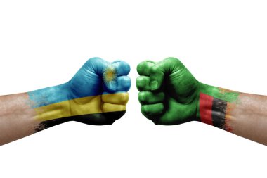 Two hands punch to each others on white background. Country flags painted fists, conflict crisis concept between rwanda and zambia