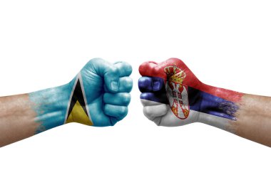 Two hands punch to each others on white background. Country flags painted fists, conflict crisis concept between saint lucia and serbia