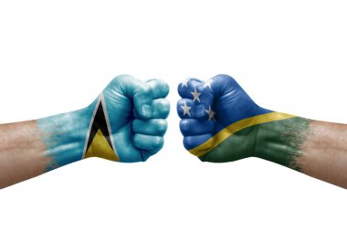 Two hands punch to each others on white background. Country flags painted fists, conflict crisis concept between saint lucia and solomon islands