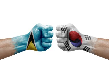 Two hands punch to each others on white background. Country flags painted fists, conflict crisis concept between saint lucia and south korea